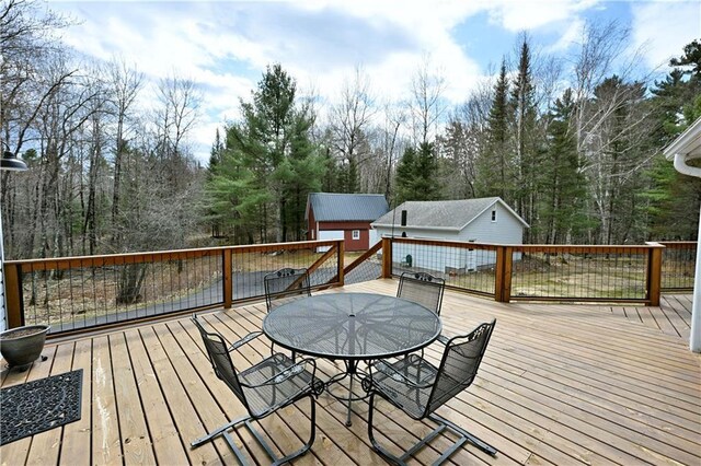 13195 Kavanaugh Rd, Cable, WI 54821 - wooden deck with outdoor dining area and an outbuilding