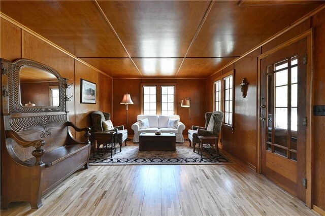 13195 Kavanaugh Rd, Cable, WI 54821 - living area featuring wood walls, ornamental molding, and hardwood / wood-style floors