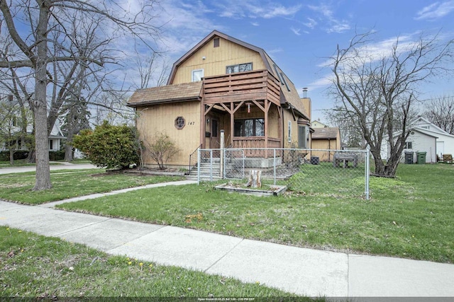 147 N James St, Kimberly, WI 54136 - colonial inspired home featuring covered porch, fence, a balcony, a front lawn, and a gambrel roof