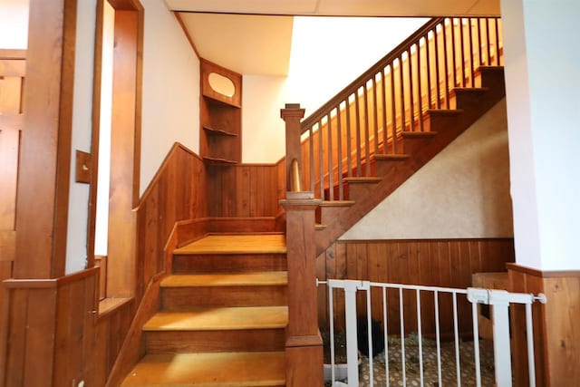 147 N James St, Kimberly, WI 54136 - staircase featuring wood walls and a wainscoted wall