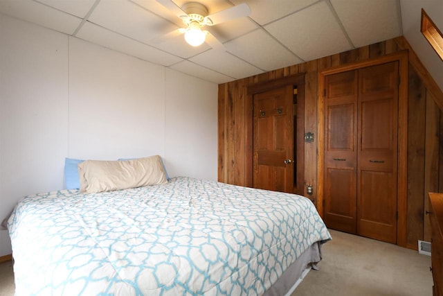 147 N James St, Kimberly, WI 54136 - bedroom with wooden walls, a ceiling fan, light carpet, and a drop ceiling