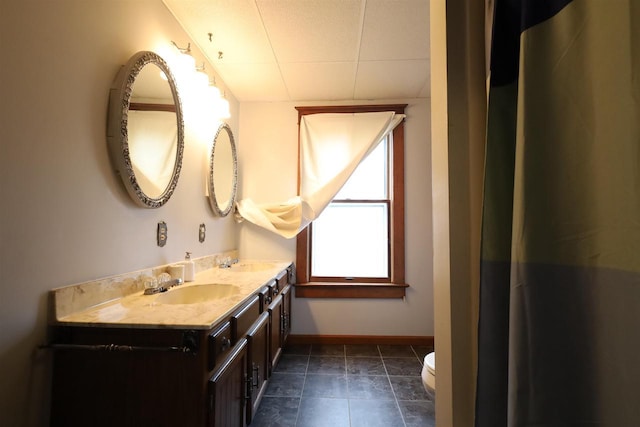 147 N James St, Kimberly, WI 54136 - bathroom with baseboards, a sink, double vanity, and toilet