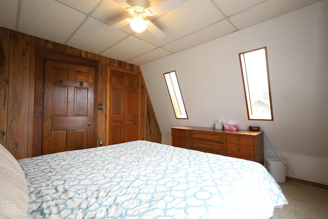 147 N James St, Kimberly, WI 54136 - bedroom featuring carpet floors, a ceiling fan, a paneled ceiling, and wooden walls