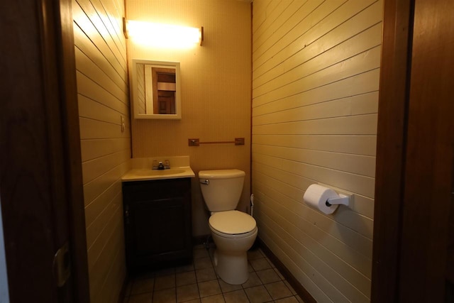147 N James St, Kimberly, WI 54136 - bathroom with tile patterned flooring, wood walls, toilet, and vanity
