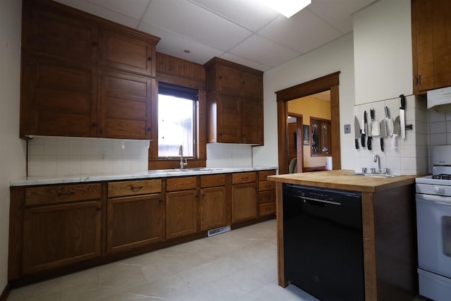 147 N James St, Kimberly, WI 54136 - kitchen with black dishwasher, white gas stove, tasteful backsplash, a sink, and wood counters
