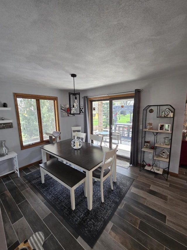 W6517 Greenwood Ct, Greenville, WI 54952 - dining area featuring wood tiled floors, a textured ceiling, baseboards, and a chandelier