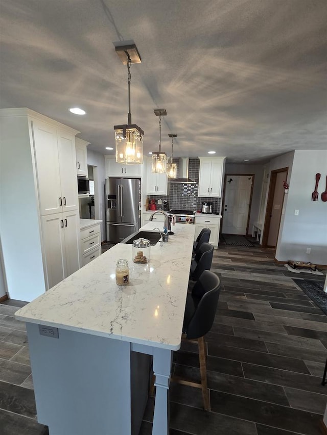 W6517 Greenwood Ct, Greenville, WI 54952 - kitchen with high end refrigerator, recessed lighting, a sink, white cabinets, and a large island with sink