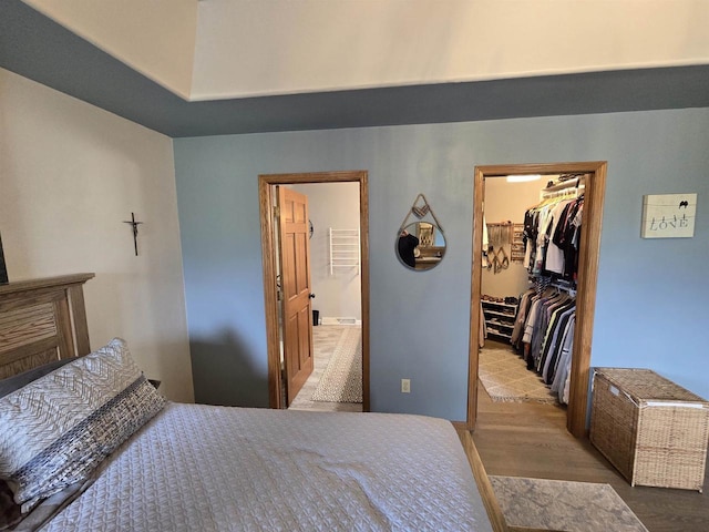 W6517 Greenwood Ct, Greenville, WI 54952 - bedroom with a spacious closet, a closet, wood finished floors, and ensuite bath