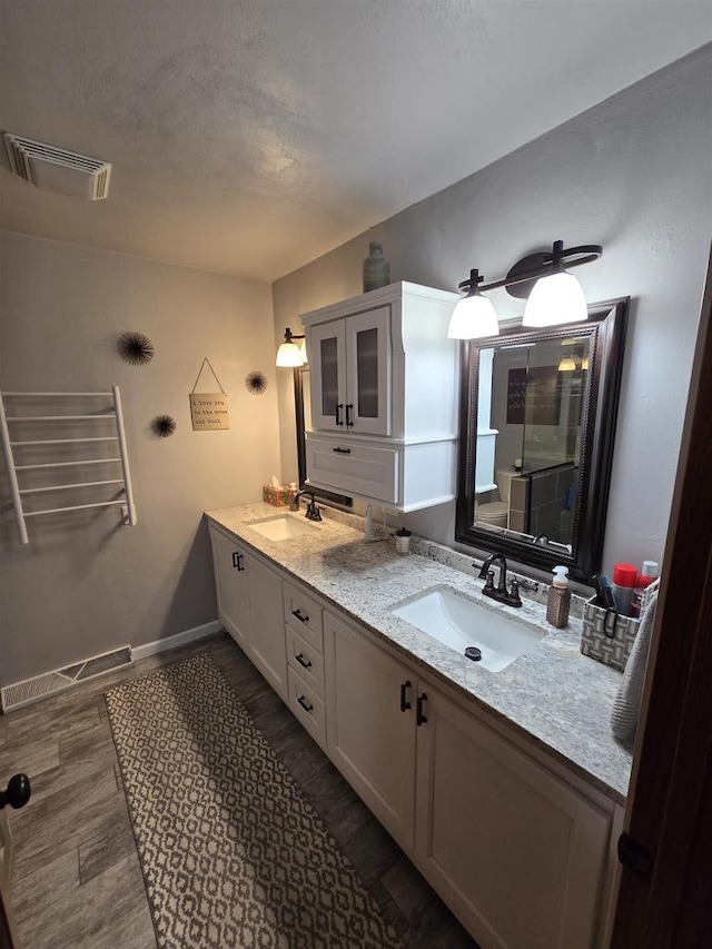 W6517 Greenwood Ct, Greenville, WI 54952 - full bathroom featuring double vanity, baseboards, and wood finished floors