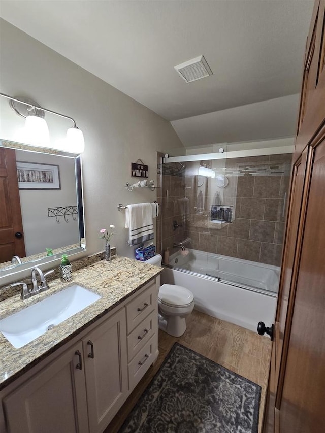 W6517 Greenwood Ct, Greenville, WI 54952 - bathroom featuring wood finished floors, vanity, vaulted ceiling, toilet, and combined bath / shower with glass door