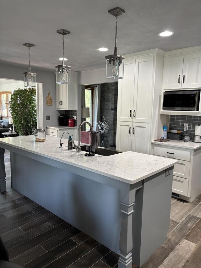 W6517 Greenwood Ct, Greenville, WI 54952 - kitchen with stainless steel microwave, tasteful backsplash, recessed lighting, plenty of natural light, and wood finished floors