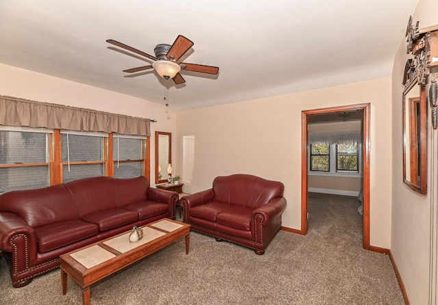 living room featuring baseboards, carpet flooring, and a ceiling fan