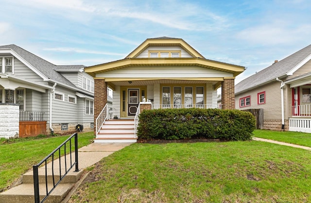 view of front of home with covered porch and a front yard
