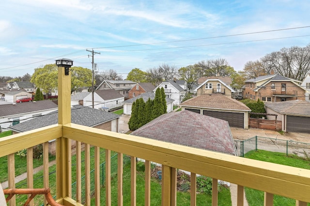 wooden deck featuring a residential view and a detached garage