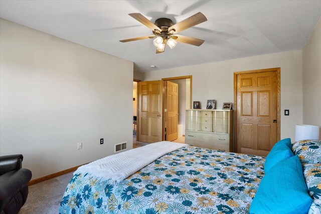 bedroom featuring baseboards, carpet flooring, ceiling fan, and visible vents