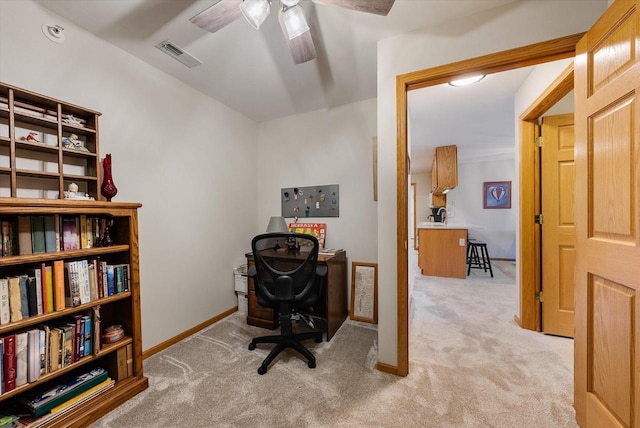 carpeted office space with visible vents, baseboards, and ceiling fan