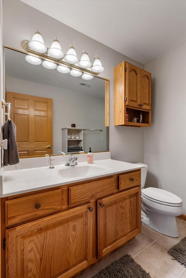 bathroom with tile patterned floors, vanity, toilet, and visible vents