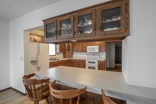 5016 Sth 96, Denmark, WI 54208 - kitchen with a peninsula, white appliances, light wood-style floors, light countertops, and a sink