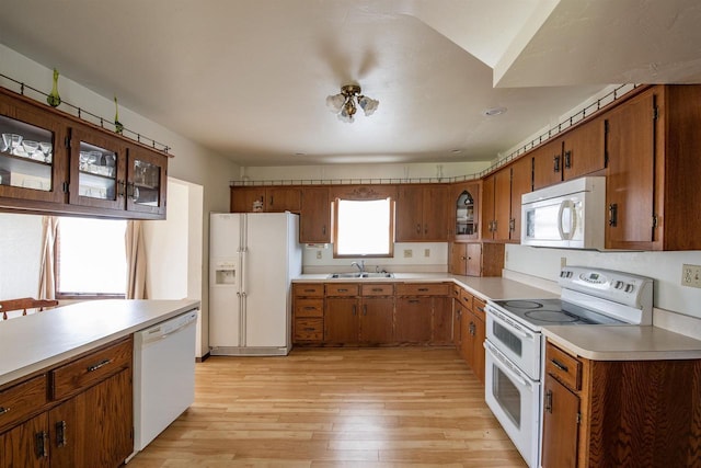 5016 Sth 96, Denmark, WI 54208 - kitchen featuring brown cabinetry, a sink, light wood-style flooring, and white appliances