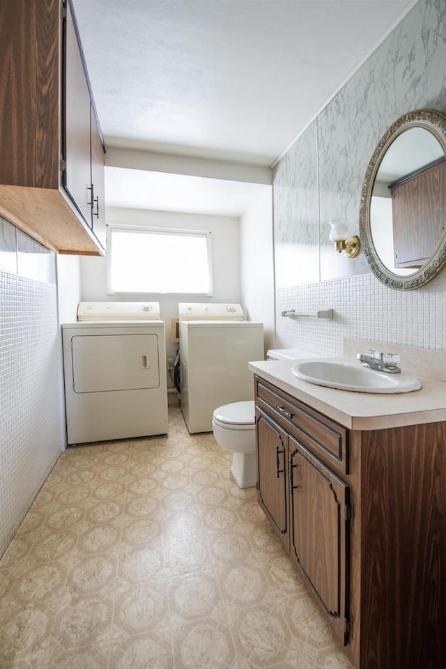 5016 Sth 96, Denmark, WI 54208 - half bathroom featuring toilet, tile patterned floors, washer and clothes dryer, and vanity