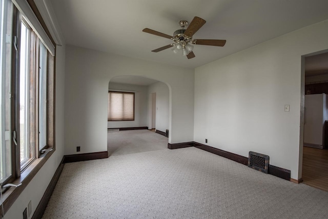 5016 Sth 96, Denmark, WI 54208 - unfurnished room with ceiling fan, arched walkways, carpet, baseboards, and visible vents
