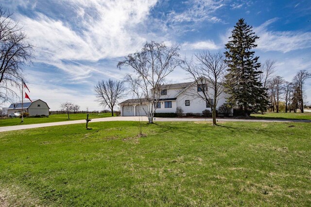5016 Sth 96, Denmark, WI 54208 - view of front of home featuring a garage, curved driveway, and a front lawn