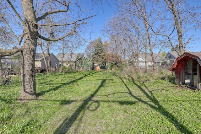 611 N St, West Bend, WI 53090 - view of grassy yard with an outdoor structure and a residential view