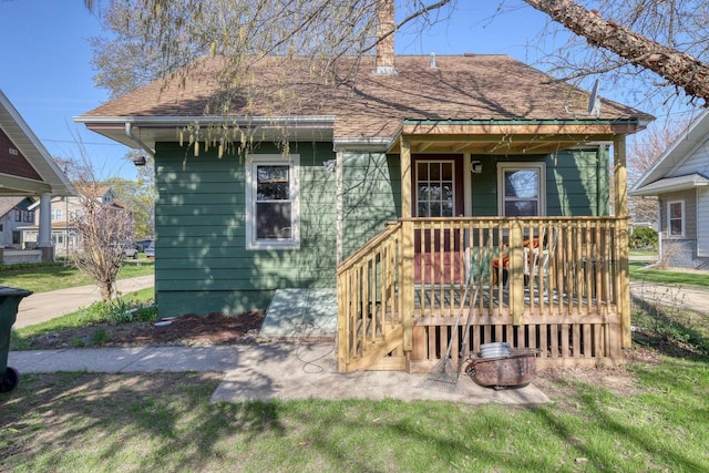 611 N St, West Bend, WI 53090 - view of front of property with roof with shingles and a chimney