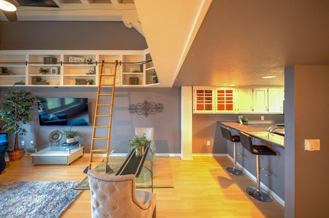 living area featuring light wood-type flooring and baseboards
