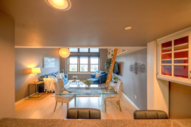 dining space featuring baseboards and wood finished floors