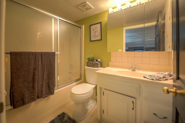bathroom with visible vents, vanity, toilet, tasteful backsplash, and enclosed tub / shower combo