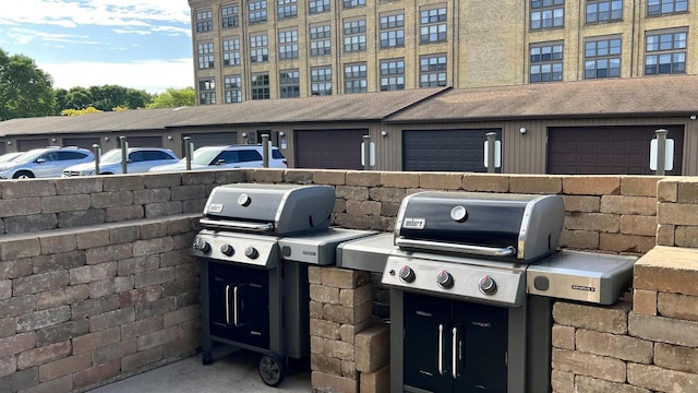 view of patio / terrace with grilling area and an attached garage