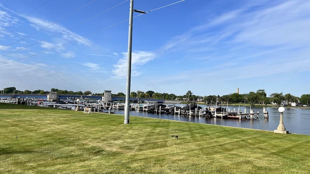 dock area featuring a lawn and a water view