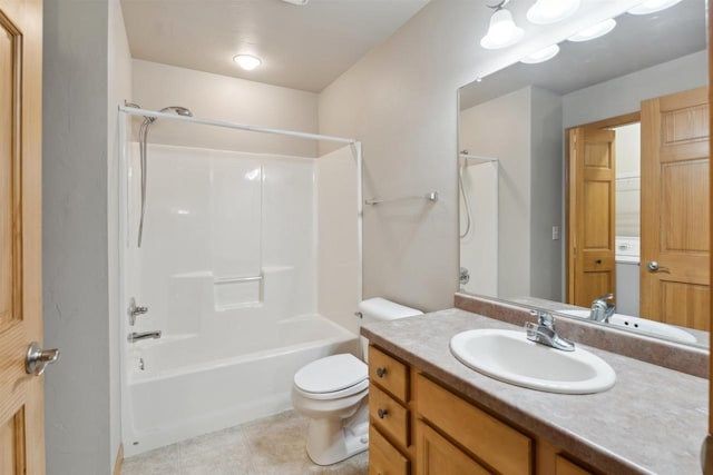 full bathroom featuring toilet, tile patterned floors, bathing tub / shower combination, and vanity