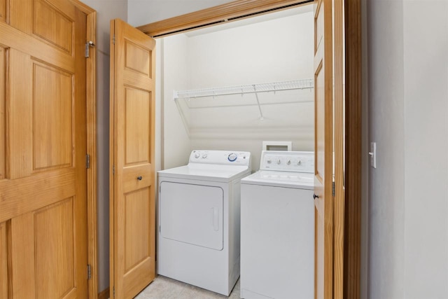 clothes washing area featuring laundry area and washer and dryer