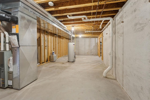 unfinished below grade area featuring heating unit and gas water heater