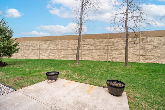view of yard featuring fence and a patio