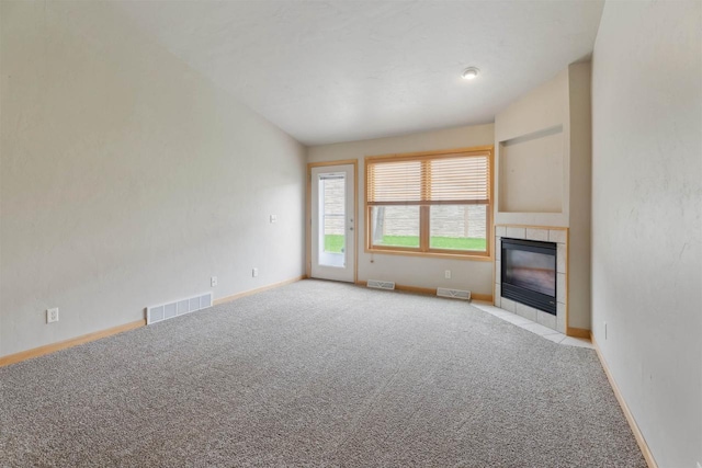 unfurnished living room with visible vents, carpet, and a fireplace