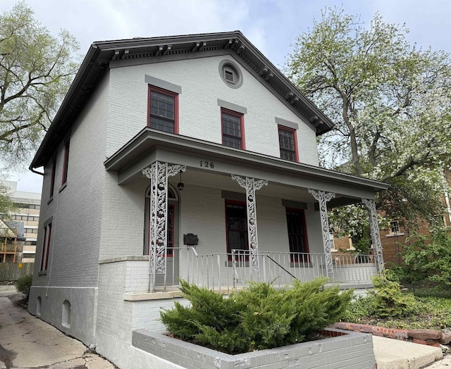 126 S Hancock St, Madison, WI 53703 - italianate home featuring brick siding and a porch