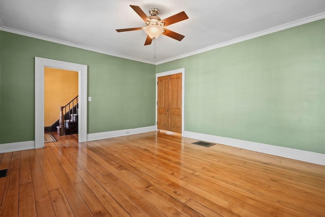 126 S Hancock St, Madison, WI 53703 - unfurnished room with baseboards, a ceiling fan, light wood-style flooring, crown molding, and stairs