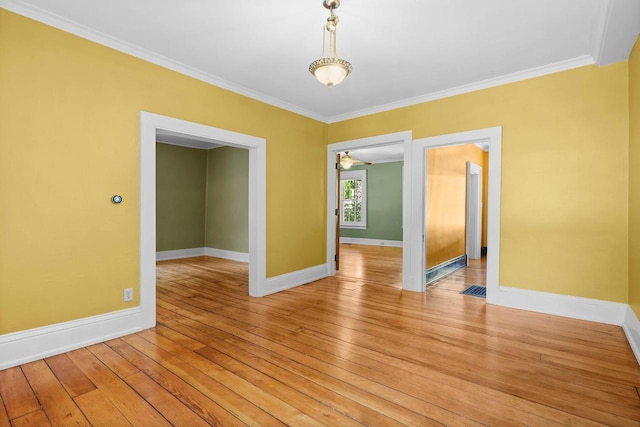 126 S Hancock St, Madison, WI 53703 - spare room featuring crown molding, light wood-style floors, and baseboards
