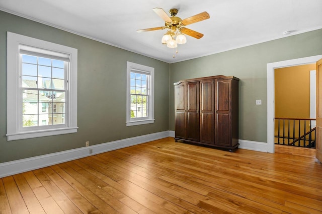 126 S Hancock St, Madison, WI 53703 - unfurnished bedroom with light wood finished floors, baseboards, ornamental molding, and ceiling fan