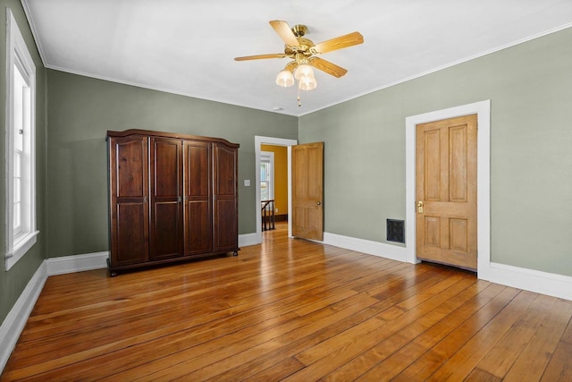 126 S Hancock St, Madison, WI 53703 - unfurnished bedroom with light wood finished floors, baseboards, ornamental molding, and a ceiling fan