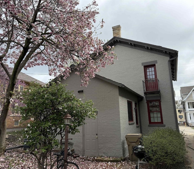 126 S Hancock St, Madison, WI 53703 - rear view of property featuring a chimney, brick siding, and a balcony