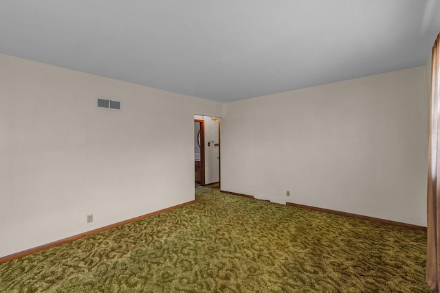 carpeted empty room featuring visible vents and baseboards