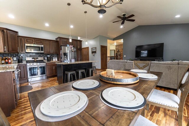 351 Alyssa St, Tomah, WI 54660 - dining room with a ceiling fan, vaulted ceiling, wood finished floors, and recessed lighting