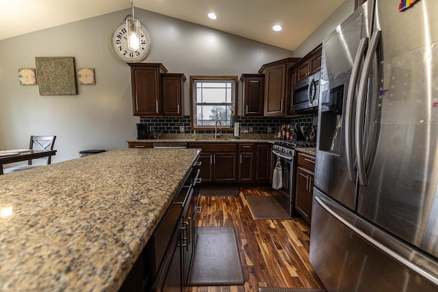 351 Alyssa St, Tomah, WI 54660 - kitchen with appliances with stainless steel finishes, vaulted ceiling, dark wood finished floors, dark brown cabinets, and a sink