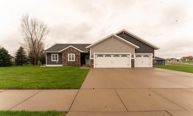 351 Alyssa St, Tomah, WI 54660 - craftsman inspired home featuring an attached garage, driveway, stone siding, and a front yard