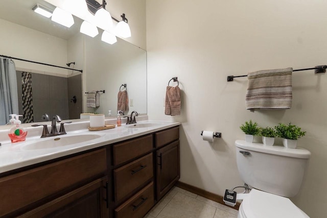 351 Alyssa St, Tomah, WI 54660 - full bathroom with baseboards, a sink, tile patterned floors, and toilet