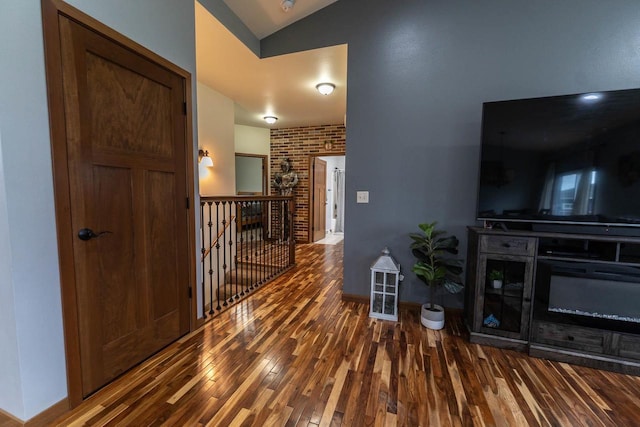 351 Alyssa St, Tomah, WI 54660 - corridor with lofted ceiling, wood finished floors, and an upstairs landing